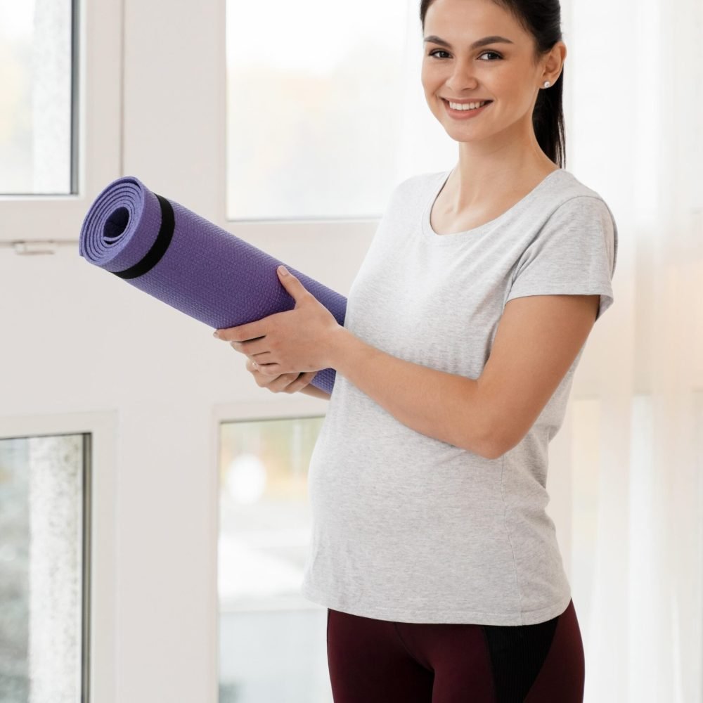pregnant-woman-holding-fitness-mat